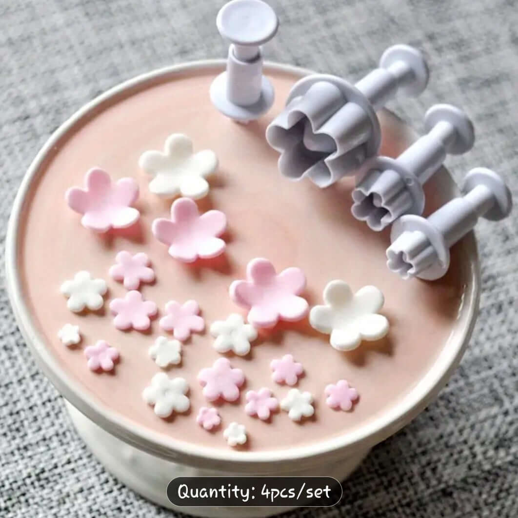Cutter Blossom Cutter Set on cake surface, featuring pink and white fondant flowers, ideal for cake decorating.