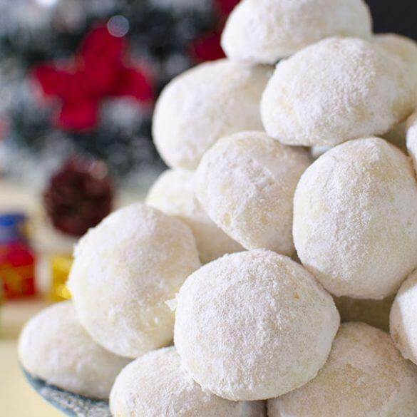 Cookies Christmas Snowball Greek Shortbread Puffs piled high, dusted with powdered sugar, perfect festive treat.