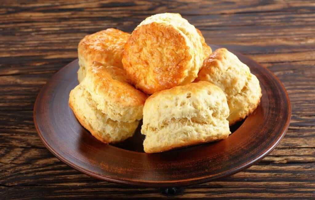 Traditional Scone Mix - Authentic British Baking Made Simple freshly baked scones on a wooden plate.